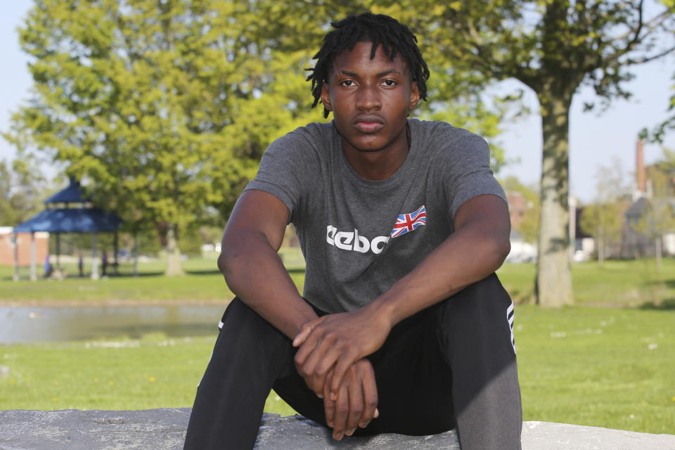 Jamari Shaw, 16, poses for a portrait in his East side neighborhood Thursday, May 11, 2023, in Buffalo, N.Y. Shaw is one of many young people who are still nervous in their surroundings since last years racist mass shooting at Tops Market. (AP Photo/Jeffrey T. Barnes)