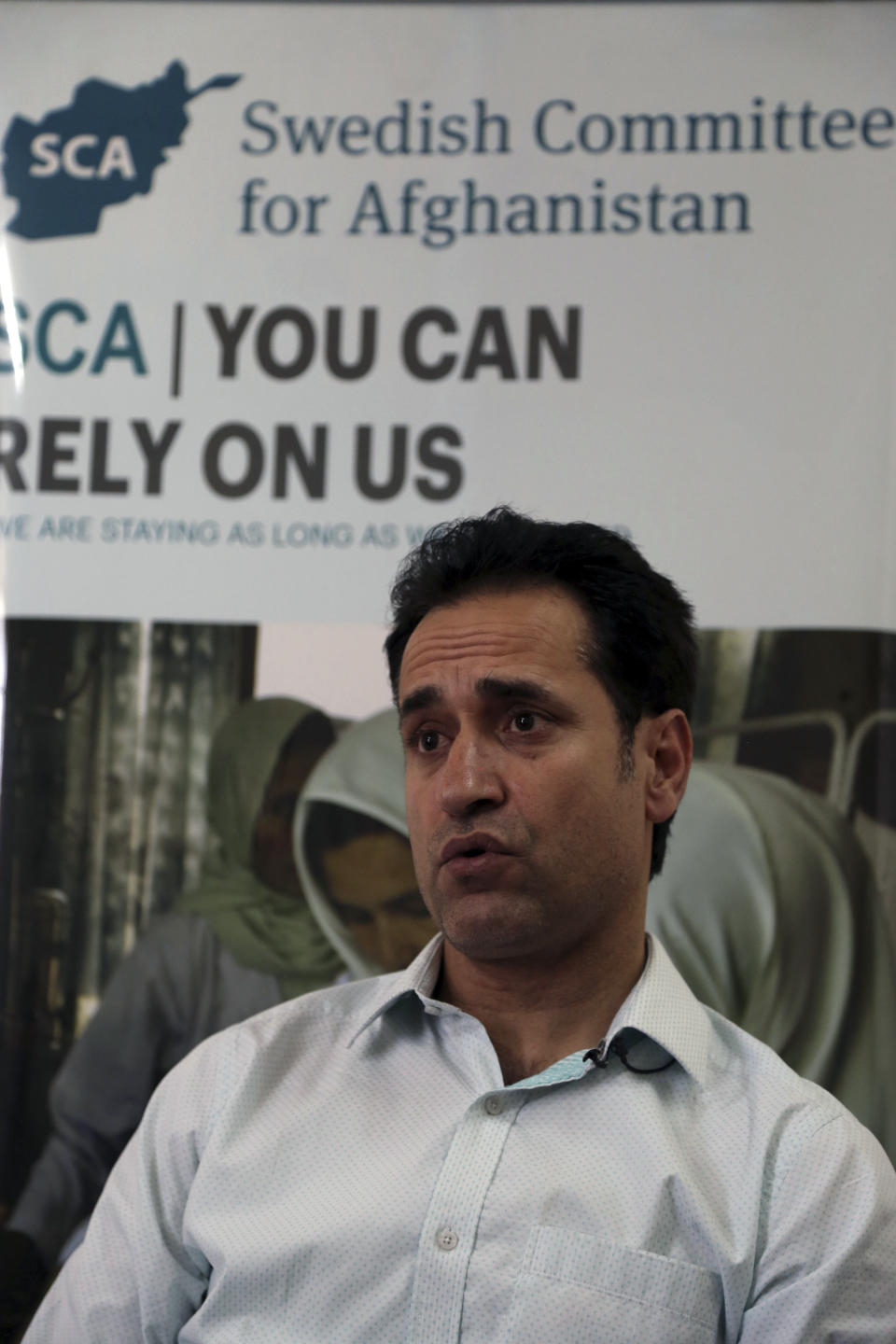 Ahmad Khalid Fahim, program director for the Swedish group, speaks during an interview with the Associated Press in Kabul, Afghanistan, Wednesday, July 17, 2019. A Swedish non-governmental organization in Afghanistan says the Taliban have forced the closure of 42 health facilities run by the non-profit group in eastern Maidan Wardan province. (AP Photo/Rahmat Gul)