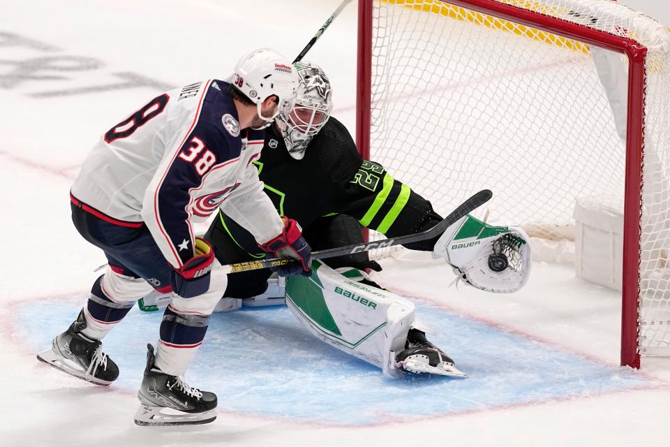 Dallas Stars goaltender Jake Oettinger (29) blocks a shot by Columbus Blue Jackets center Boone Jenner (38) in the third period of an NHL hockey game, Monday, Oct. 30, 2023, in Dallas. (AP Photo/Tony Gutierrez)