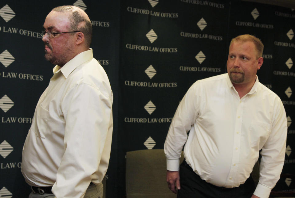 John Jentz, left, of St. Peter, Minn., and Robert Schmidt, of Hutchinson, Minn., who were both severely burned in April 2010 at a grain elevator explosion in downstate Illinois leave after speaking about their settlement at a news conference at the Clifford Law Offices Monday, June 4, 2012, in Chicago. Jentz described his losses after a federal jury awarded him $75 million in a lawsuit against ConAgra Foods Inc. and a subcontractor. Jentz, Schmidt and a third co-worker from Iowa were awarded a total $181 million in damages. (AP Photo/M. Spencer Green)