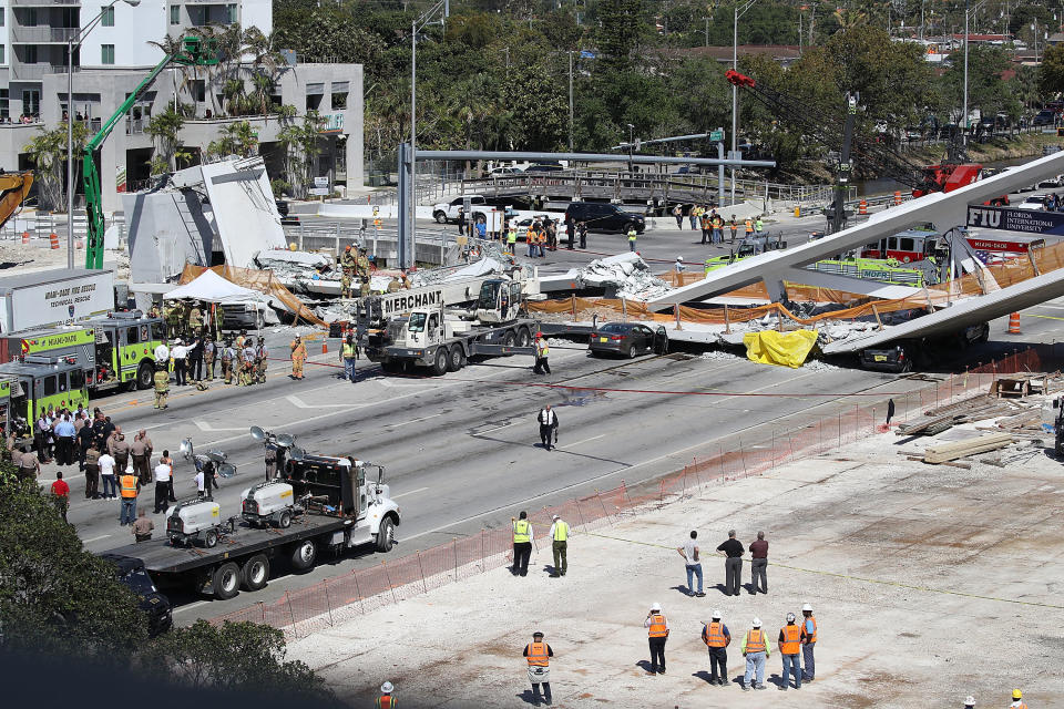 Miami-Dade Fire Rescue personnel and other rescue units work at the scene.