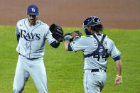 Tampa Bay Rays relief pitcher John Curtiss, left, and catcher Kevan Smith celebrate after defeating the Baltimore Orioles in the second game of a baseball doubleheader, Thursday, Sept. 17, 2020, in Baltimore. The Rays won 10-6 to clinch a playoff berth. (AP Photo/Julio Cortez)