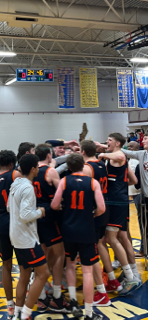 Members of the Milton Academy boys basketball team celebrate after beating St. Sebastian's, 77-76, on Sunday, March 5, 2023 to claim the Class A NEPSAC championship at Western New England University in Springfield.