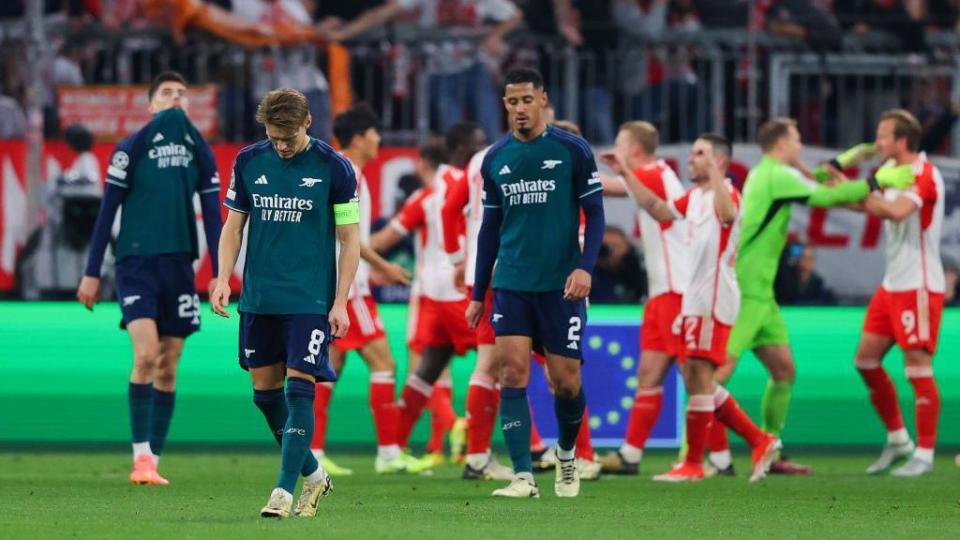 Arsenal players look dejected as Bayern players celebrate
