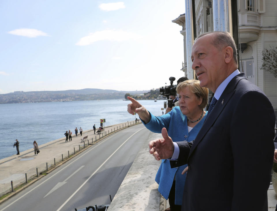 Turkish President Recep Tayyip Erdogan, left, and German Chancellor Angela Merkel talk to each other at Huber Villa presidential palace ahead of their meeting, in Istanbul, Saturday, Oct. 16, 2021. Merkel and Erdogan are expected to discuss Ankara's relationship with Germany and the European Union as well as regional issues including Syria and Afghanistan. The chancellor's trip is one of her last before she leaves her position. (Turkish Presidency Pool via AP)