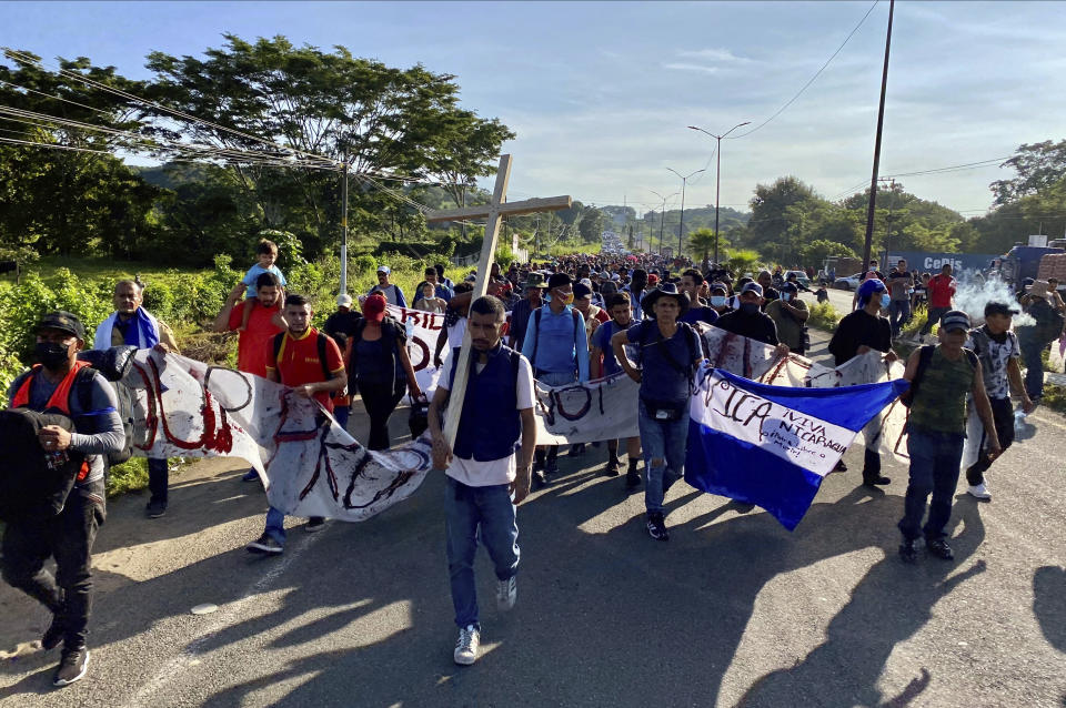 A caravan of migrants, most from central America, head north as they depart from Tapachula, Mexico, Saturday, Oct. 23, 2021. Immigration activists say they will lead migrants out of the southern Mexico city of Tapachula Saturday at the start of a march they hope will bring them to Mexico City to press their case for better treatment. (AP Photo/ Edgar H. Clemente)