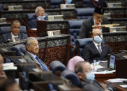 Former Prime Minister Mahathir Mohamad, left, attend a session of the lower house of parliament in Kuala Lumpur, Malaysia, Monday, July 13, 2020. (AP Photo/Vincent Thian)
