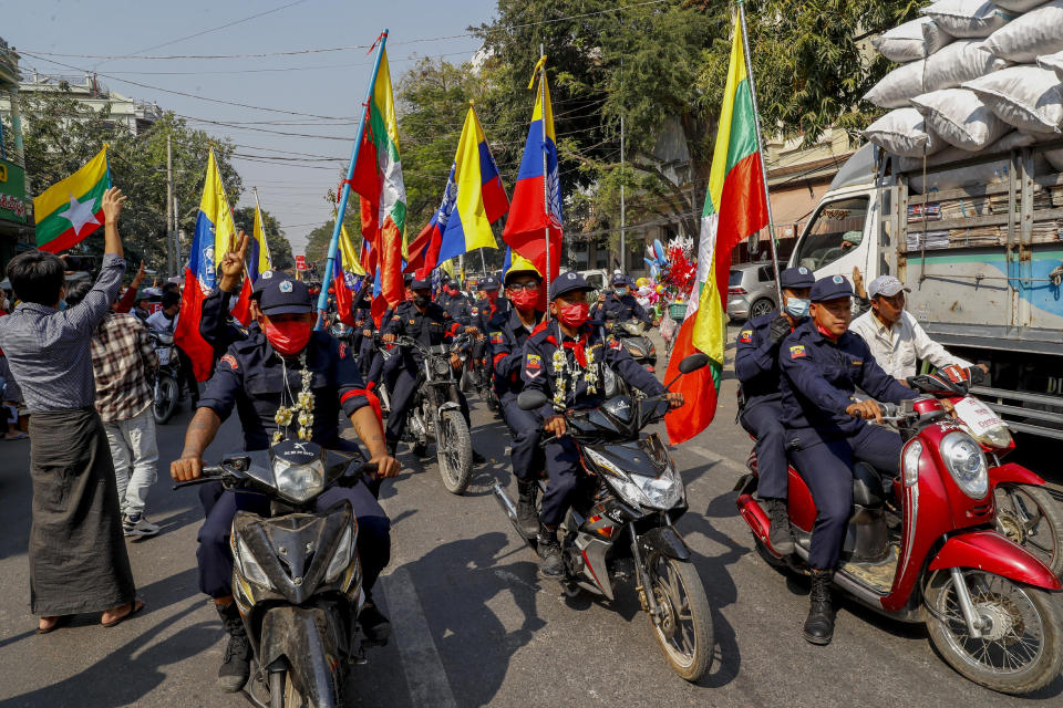 Firefighters lead a group of demonstrators on motor bikes against the recent military coup in Mandalay, Myanmar, Friday, Feb. 12, 2021. Myanmar's coup leader used the country's Union Day holiday on Friday to call on people to work with the military if they want democracy, a request likely to be met with derision by protesters who are pushing for the release from detention of their country's elected leaders. (AP Photo)