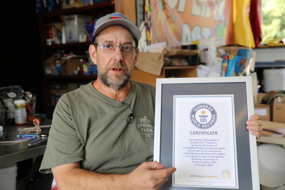 Ed Currie holds up his certification that his new Pepper X variety of peppers is the hottest in the world according to the Guinness Book of World Records on Tuesday, Oct. 10, 2023, in Fort Mill, S.C.
