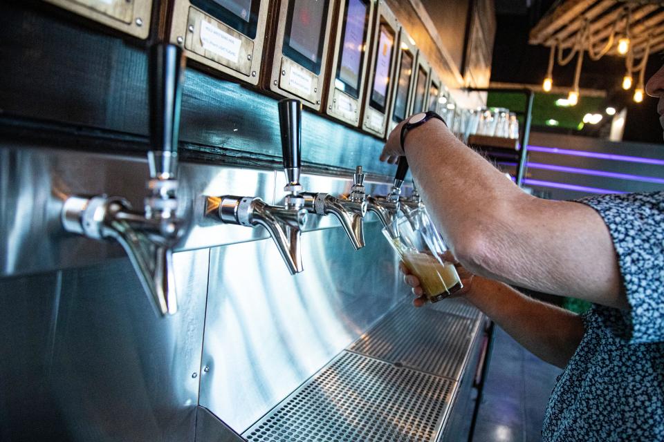 A patron fills his glass with beer at The Causeway, a restaurant/bar along Old U.S. 41 in Bonita Springs. March 19, 2024.