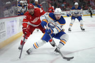 Buffalo Sabres defenseman Bowen Byram (4) protects the puck from Detroit Red Wings center Joe Veleno (90) in the first period of an NHL hockey game Saturday, March 16, 2024, in Detroit. (AP Photo/Paul Sancya)