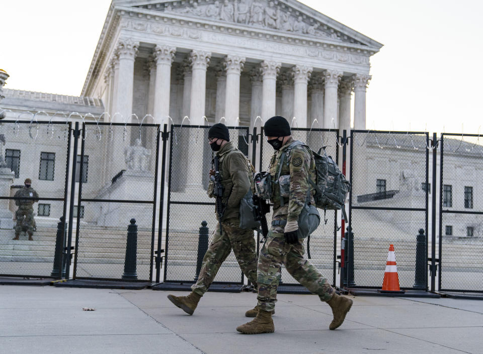 National Guard troops keep watch at the Supreme Court on Capitol Hill in Washington, early Thursday, March 4, 2021, amid intelligence warnings that there is a "possible plot" by a group of militia extremists to take control of the Capitol on March 4 to remove Democrats from power. The threat comes nearly two months after thousands of supporters of then-President Donald Trump stormed the Capitol in a violent insurrection as Congress was voting to certify Joe Biden's electoral win. (AP Photo/J. Scott Applewhite)