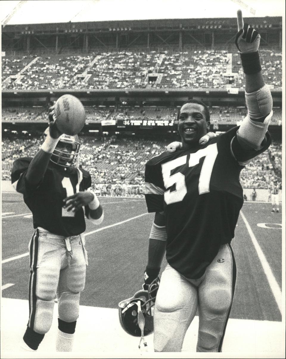 Michigan Panthers Anthony Carter and John Corker celebrate a win.