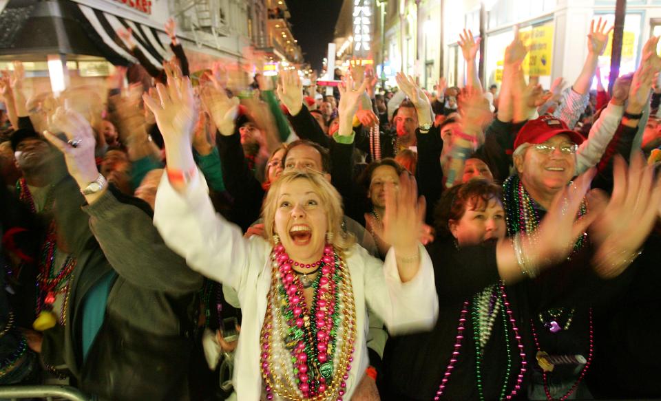 Donna Manwaring calls for beads at the entrance to Bourbon St, as the Endymion parade rolls down Canal Street during Mardi Gras festivities in New Orleans, 26 February 2006. New Orleans is celebrating its first Mardi Gras since Hurricane Katrina. AFP PHOTO / Robyn Beck