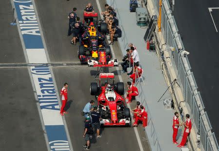 Formula One - Grand Prix of Europe - Baku, Azerbaijan - 16/6/16 - Mechanics rest near the cars at the pit lane. REUTERS/Maxim Shemetov