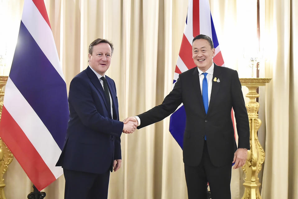 In this photo released by the Government Spokesman Office, Britain's Foreign Secretary, David Cameron, left, shakes hand with Thailand's Prime Minister Srettha Thavisin, at the Government house in Bangkok, Thailand, Wednesday, March 20, 2024. (Thailand's Government Spokesman Office via AP)