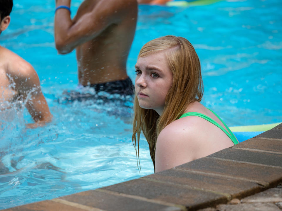 Elsie Fisher sitting in the pool.