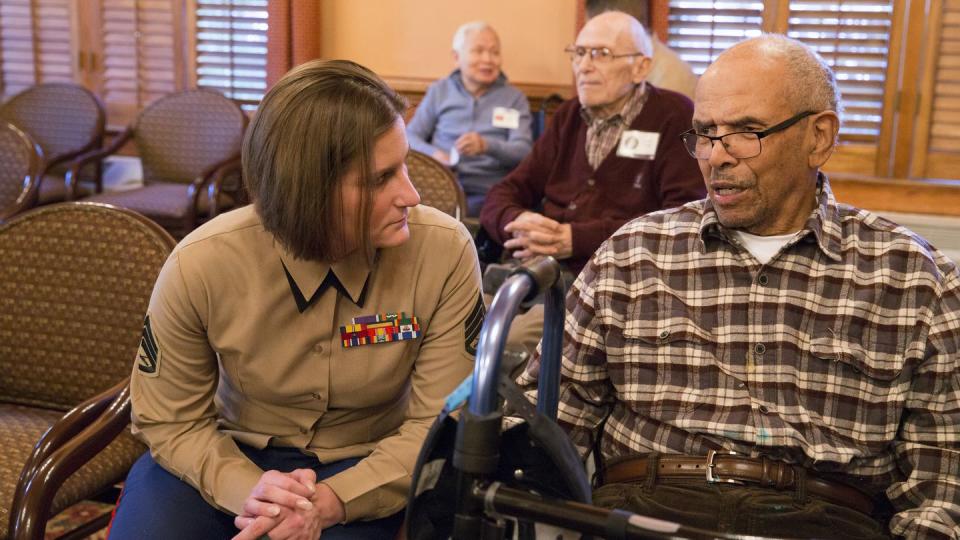 Marine Corps Staff Sgt. Amanda J. Eason, a planner at Marine Corps Base Quantico, speaks with a resident at the Heatherwood Retirement Home during a Veterans Day visit in Burke, Virginia, in 2016. (Staff Sgt. Sarah R. Hickory/Marine Corps)