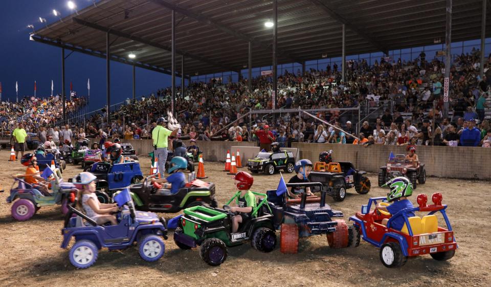 Youngsters compete in the Power Wheels demolition derby at the Monroe County Fair Tuesday evening.