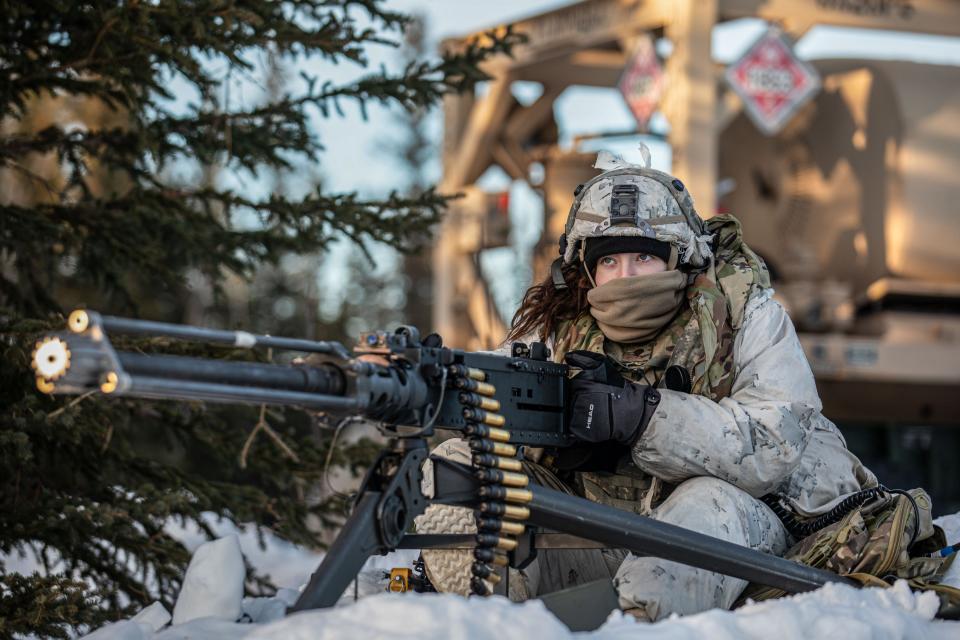 U.S. Army Spc. Sammantha Ohm assigned to 5th Squadron, 1st Calvary Regiment, Delta Co, 1st Infantry Brigade Combat Team, 11th Airborne Division pulls security on the M2HB .50-caliber machine gun during the Joint Pacific Multinational Readiness Center 24-02 exercise at Donnelly Training Area, Alaska, Feb. 17, 2024.