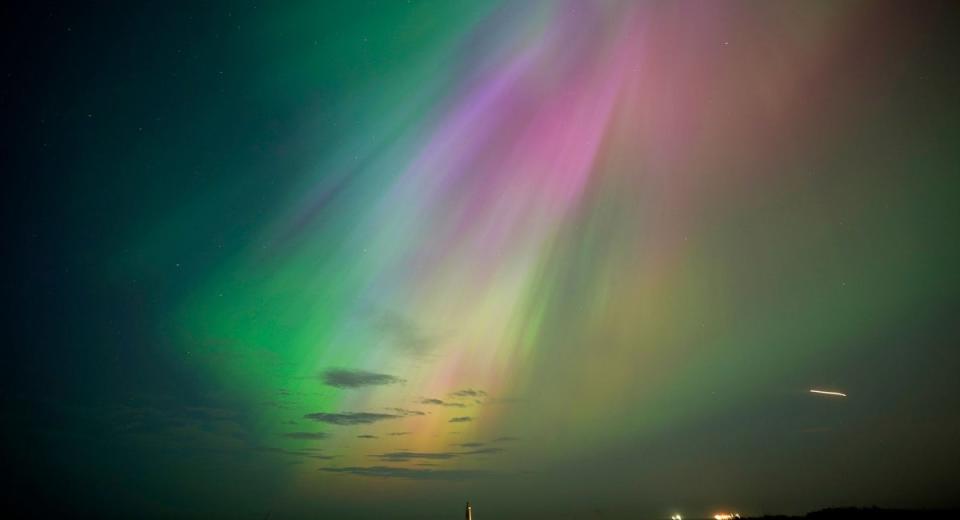 The aurora borealis, also known as the northern lights, glow on the horizon at St Mary's Lighthouse in Whitley Bay in May (Owen Humphreys/PA Wire)