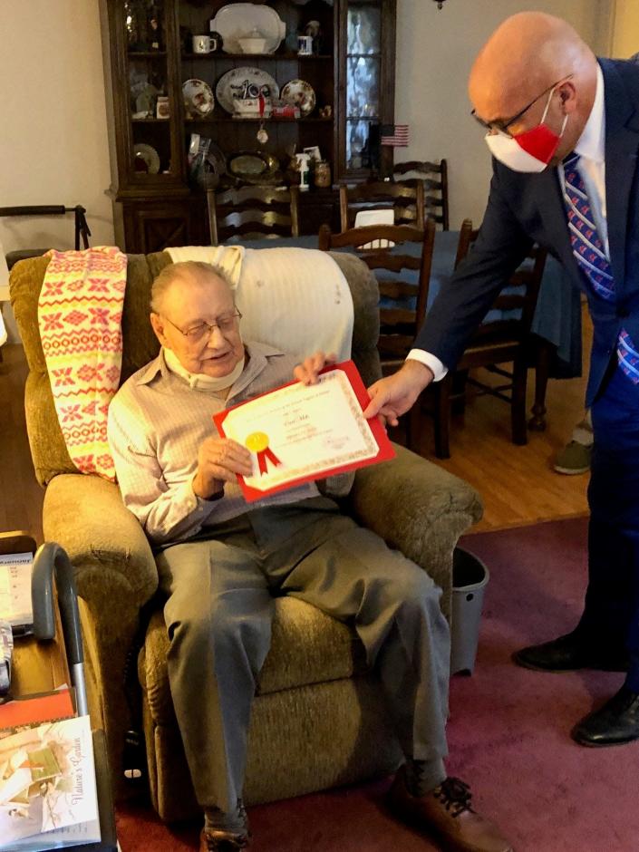 After a chilly ceremony outside, Fran&#xe7;ois Kloc, honorary consul of France in Jacksonville, and Earl Mills of Live Oak went inside to pose with a certificate that goes along with the Chevalier de la L&#xe9;gion d&#x002019;Honneur, the highest French distinction for military and civil accomplishments. Mills, 100, was a U.S. paratrooper who took part in the liberation of Europe during World War II.