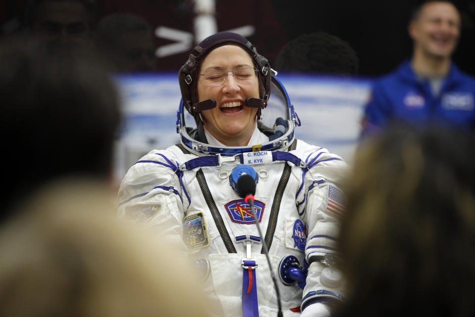 U.S. astronaut Christina Hammock Koch, member of the main crew of the expedition to the International Space Station (ISS), speaks with her relatives through a safety glass prior the launch of Soyuz MS-12 space ship at the Russian leased Baikonur cosmodrome, Kazakhstan, Thursday, March 14, 2019. (AP Photo/Dmitri Lovetsky, Pool)