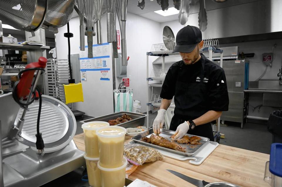 Executive Chef Larry Lane works on de-boning rabbit at EnRich Bistro in Bradenton on Tuesday, May 14, 2024.