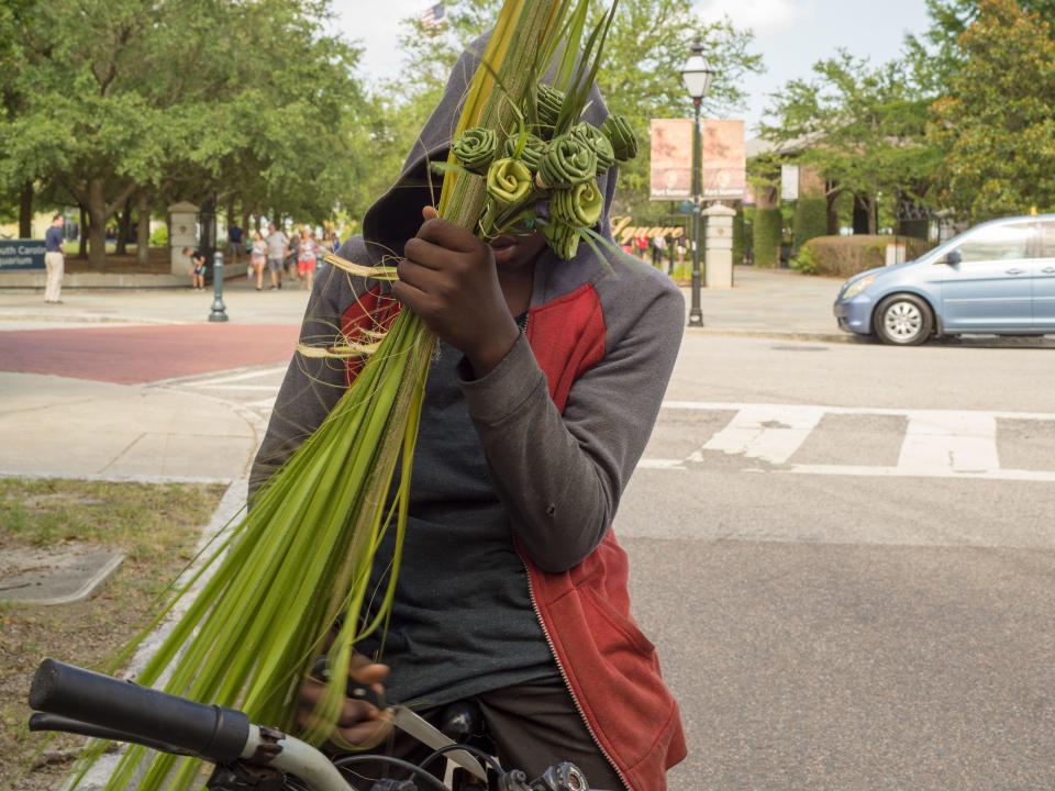 It was upsetting to the photographer to find a young boy in South Carolina with a knife in his hand, selling palms at Liberty Square, the old site of Charleston’s slavery port.