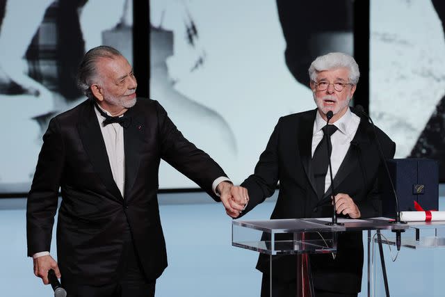 <p>Pascal Le Segretain/Getty </p> Francis Ford Coppola (left) presents George Lucas with the Palme d'Or