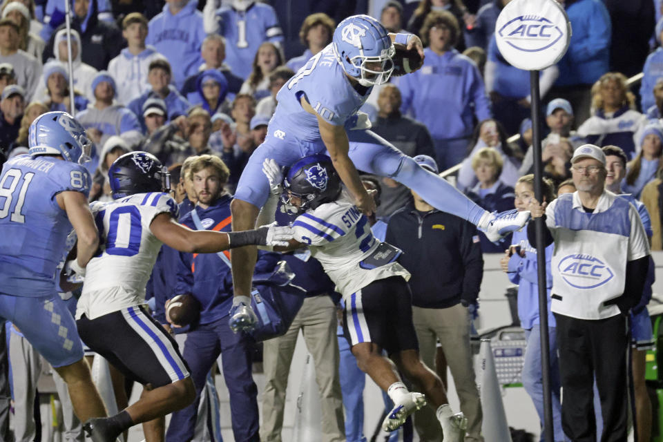 North Carolina quarterback Drake Maye (10) tries to hurdle Duke safety Jaylen Stinson (2) during the second half of an NCAA college football game Saturday, Nov. 11, 2023, in Chapel Hill, N.C. (AP Photo/Chris Seward)