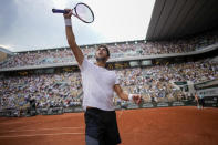 Argentina's Tomas Martin Etcheverry celebrates after scoring a point against Germany's Alexander Zverev during their quarterfinal match of the French Open tennis tournament at the Roland Garros stadium in Paris, Wednesday, June 7, 2023. (AP Photo/Christophe Ena)