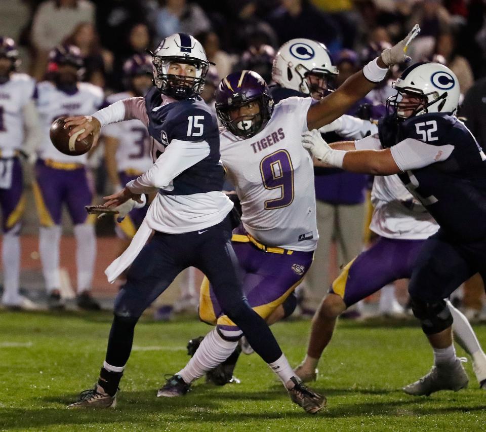 Central Valley Christian's Brent Kroeze drops back to pass against Lemoore during their Central Section Division II high school football championship playoff game in Visalia, Calif., Friday, Nov. 24, 2023.