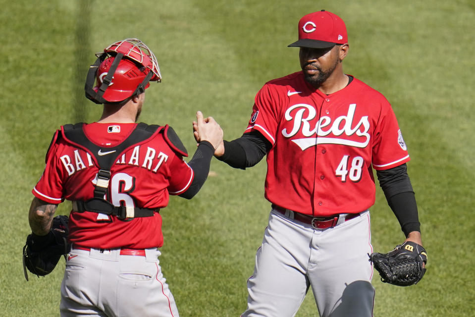 Cincinnati Reds relief pitcher Mychal Givens (48) celebrates with catcher Tucker Barnhart after getting the final out of a baseball game against the Pittsburgh Pirates in Pittsburgh, Thursday, Sept. 16, 2021. The Reds won 1-0. (AP Photo/Gene J. Puskar)