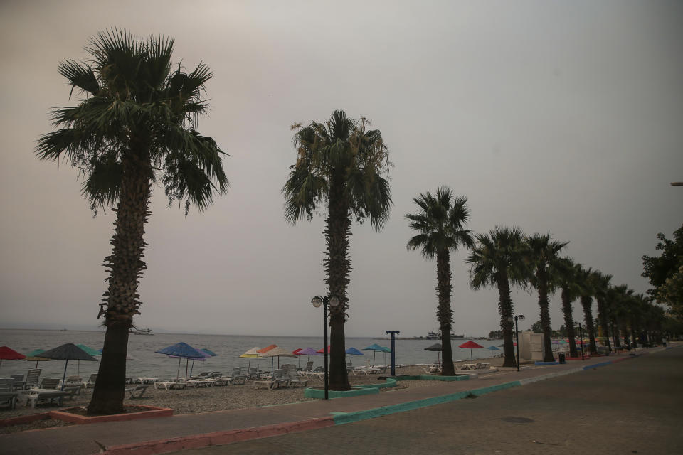 The Oren beach near the Kemerkoy Power Plant, a coal-fueled power plant, in Milas, Mugla in southwest Turkey, Thursday, Aug. 5, 2021. A wildfire that reached the compound of a coal-fueled power plant in southwest Turkey and forced evacuations by boats and cars, was contained on Thursday after raging for some 11 hours, officials and media reports said. (AP Photo/Emre Tazegul)