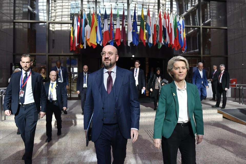 European Council President Charles Michel, center left, and European Commission President Ursula von der Leyen, center right, walk together prior to a media conference at an EU summit in Brussels, Friday, Oct. 21, 2022. European Union leaders are gathered Friday to take stock of their support for Ukraine after President Volodymyr Zelenskyy warned that Russia is trying to spark a refugee exodus by destroying his war-ravaged country's energy infrastructure. (AP Photo/Geert Vanden Wijngaert)