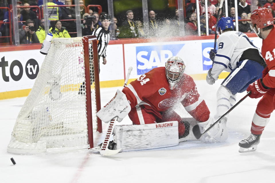 Detroit goalkeeper Alex Lyon, left, saves a shot from Toronto's Calle Jarnkrok during the NHL Global Series Sweden ice hockey match between Toronto Maple Leafs and Detroit Red Wings and at Avicii Arena in Stockholm, Sweden, Friday Nov. 17, 2023. (Henrik Montgomery/TT News Agency via AP)