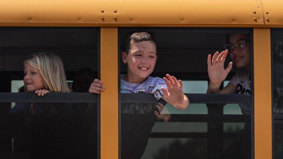 Students wave goodbye to faculty and staff at Elizabeth Lane Elementary Wednesday, June 8, 2022. Faculty and staff wave, cheer, and blow bubbles to send off students on last day of school. We call it “bubbles and busses,” says Crystal Lail, the principal of Lane Elementary. Lail says that it’s an annual tradition spanning back more than a decade.