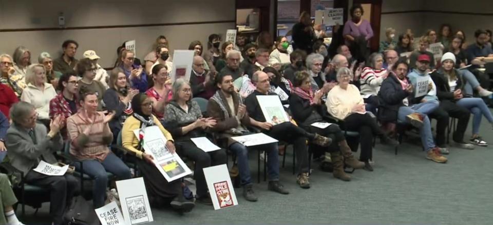 The crowd at the Bloomington City Council meeting on March 27, 2024, applauds after a comment from council member Andy Ruff.
