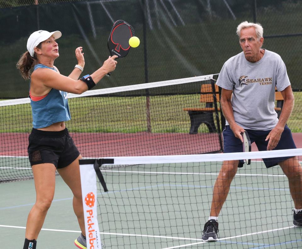 Chris West of Stratham returns a serve as her pickleball partner, Stephan Hermans of Exeter, is ready to do his part while playing doubles at Exeter Recreation Park July 21, 2023.