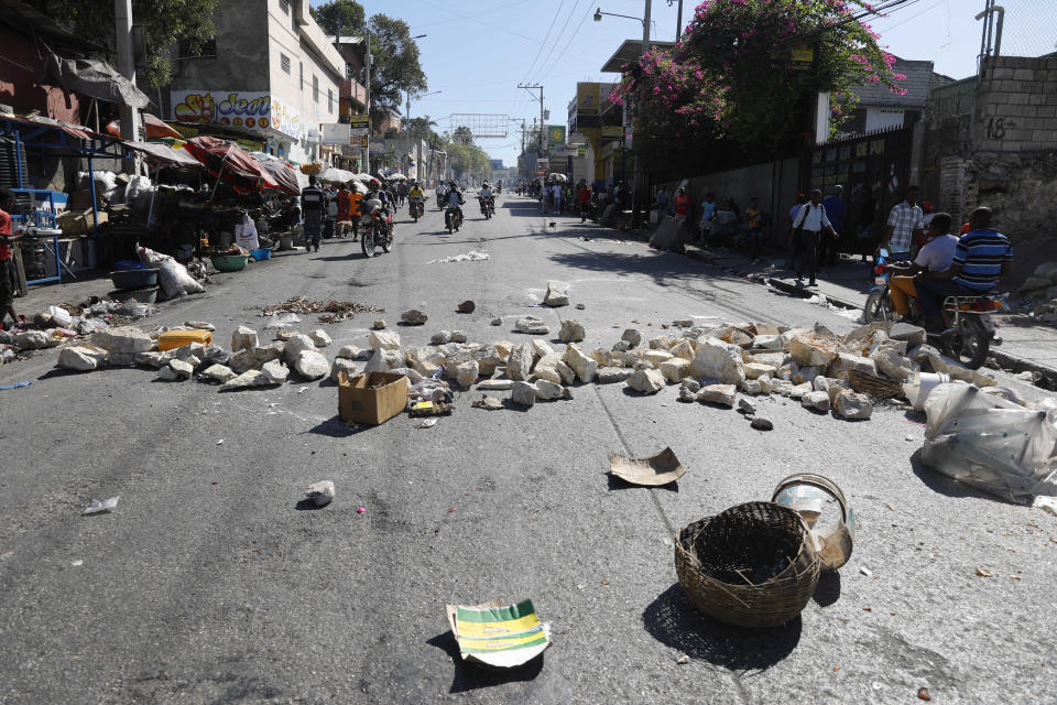 A streets is blocked with stones and debris placed there by protesters to call attention to the country's insecurity and demanding the resignation of the prime minister, in Port-au-Prince, Haiti, Thursday, Jan. 18, 2024. (AP Photo/Odelyn Joseph)