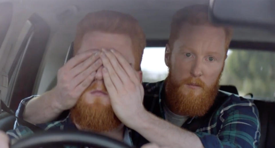 A man sits behind a driver and covers his eyes in a confronting new ad campaign released by the TAC. Source: TAC