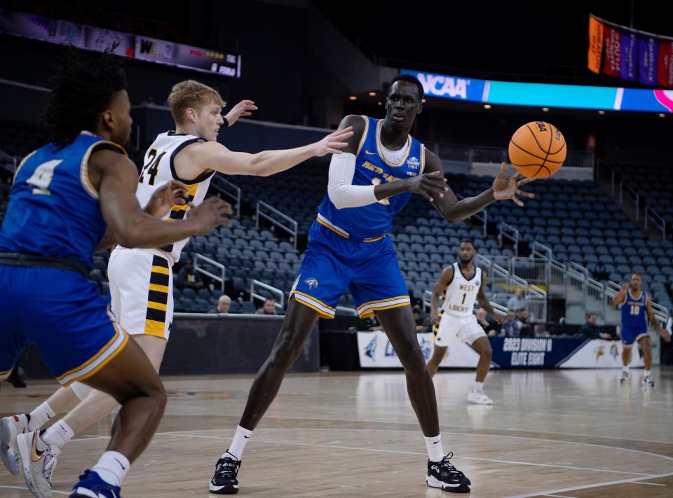 New Haven's Majur Majak (12) passes to New Haven's Quashawn Lane (4) as West Liberty's Ben Sarson (24) guards him during their NCAA Division II quarterfinal game at Ford Center in Evansville, Ind., Tuesday afternoon, March 21, 2023.