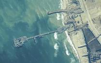 The image provided by U.S, Central Command, shows U.S. Army soldiers assigned to the 7th Transportation Brigade (Expeditionary), U.S. Navy sailors assigned to Amphibious Construction Battalion 1, and Israel Defense Forces placing the Trident Pier on the coast of Gaza Strip on Thursday, May 16, 2024. The temporary pier is part of the Joint Logistics Over-the-Shore capability. The U.S. military finished installing the floating pier on Thursday, with officials poised to begin ferrying badly needed humanitarian aid into the enclave besieged over seven months of intense fighting in the Israel-Hamas war. (U.S. Central Command via AP)