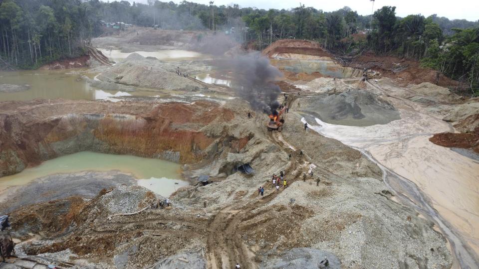 The National Police destroy an illegal gold mining operation with soldiers standing guard as part of the Armed Forces' "Operation Guamuez III" in Magui Payan, Colombia, Tuesday, April 20, 2021. Illegal gold mining is common in Colombia, especially wildcat mines in poverty-stricken areas dominated by criminal gangs with little state presence. (AP Photo/Fernando Vergara)