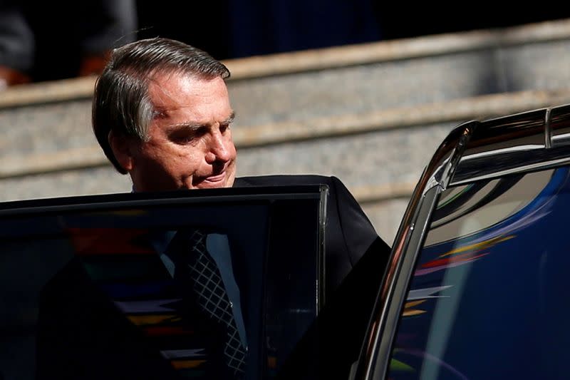 FILE PHOTO: Brazil's President Jair Bolsonaro walks from Catholic church in Brasilia