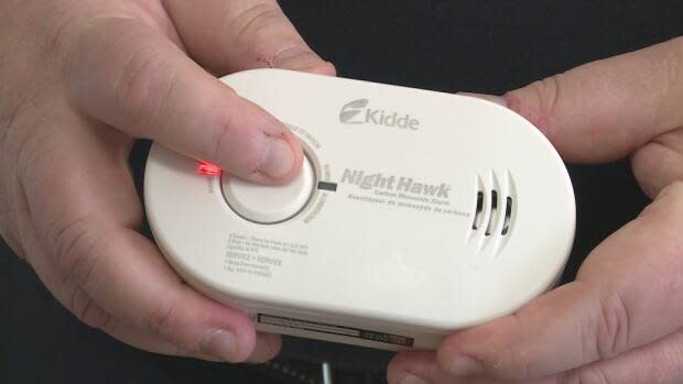 A small battery operated carbon monoxide detector has a loud beeping sound when levels are detected that could be harmful.  (Laura Meader/CBC - image credit)