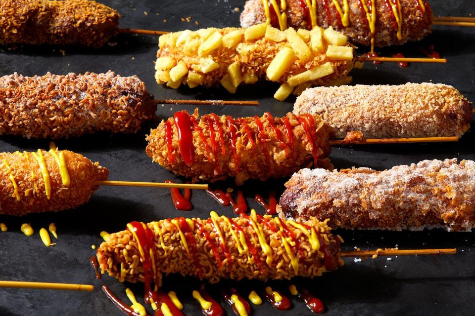 korean corn dog topped with sugar, ketchup and mustard