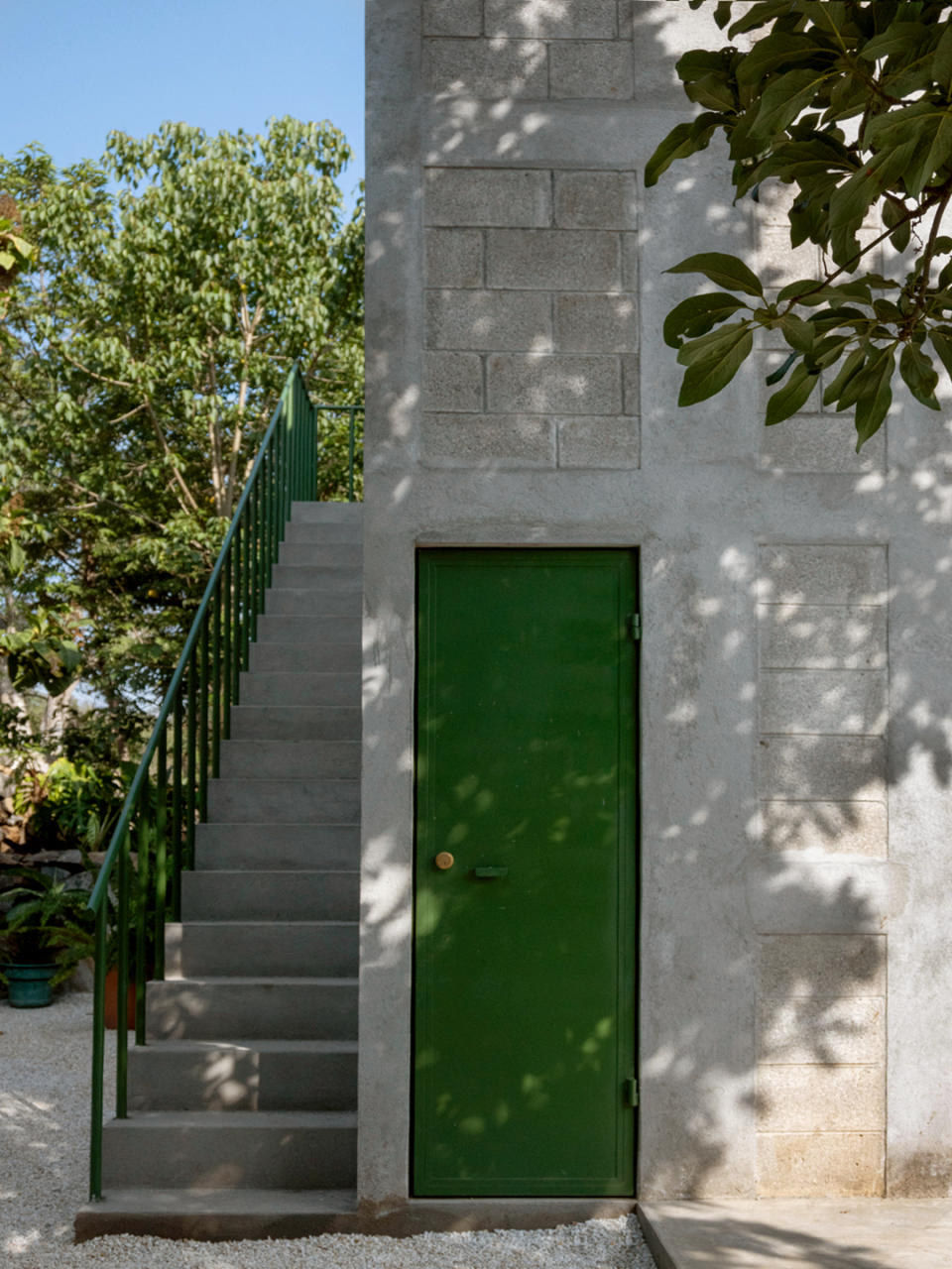 view of outdoor staircase with green door