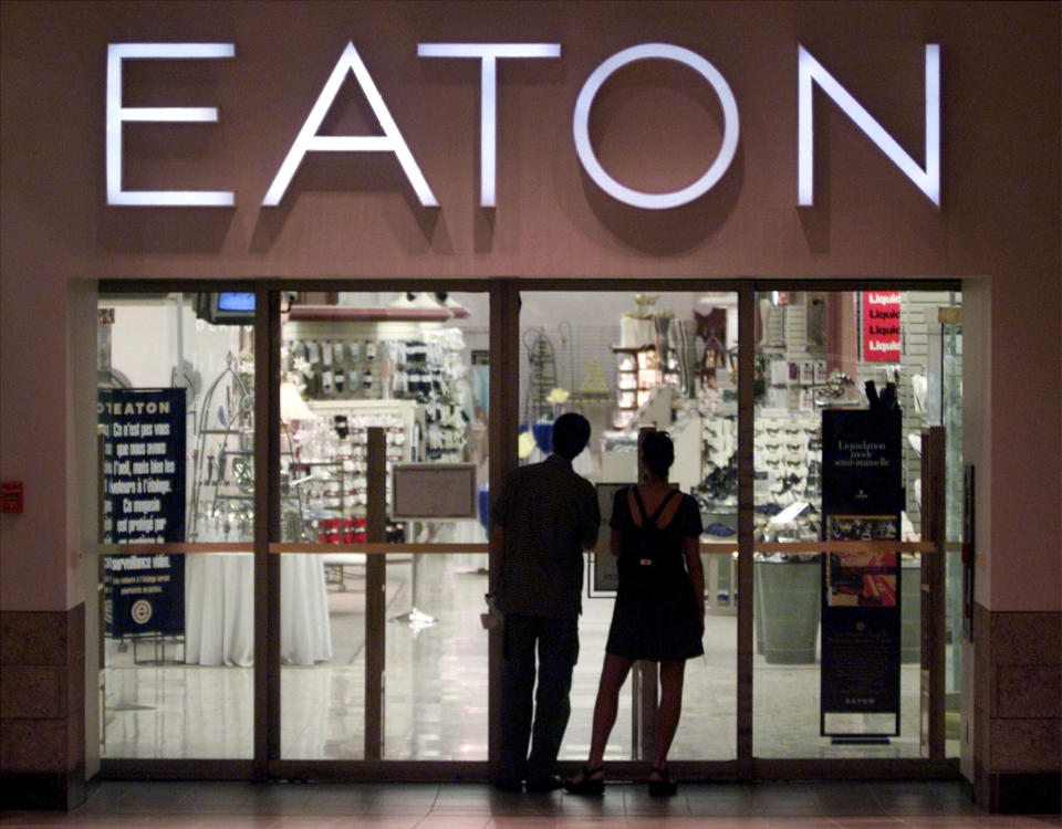 Shoppers peer into the closed Eaton's flagship store in downtown Montreal, August 20. Teetering on the brink of collapse, Canada's oldest department store chain, T. Eaton Co. closed it's nine stores in Quebec, wiping out over 1,000 jobs. The company is expected to make an announcement within days on the future of its remaining 55 stores.    SB